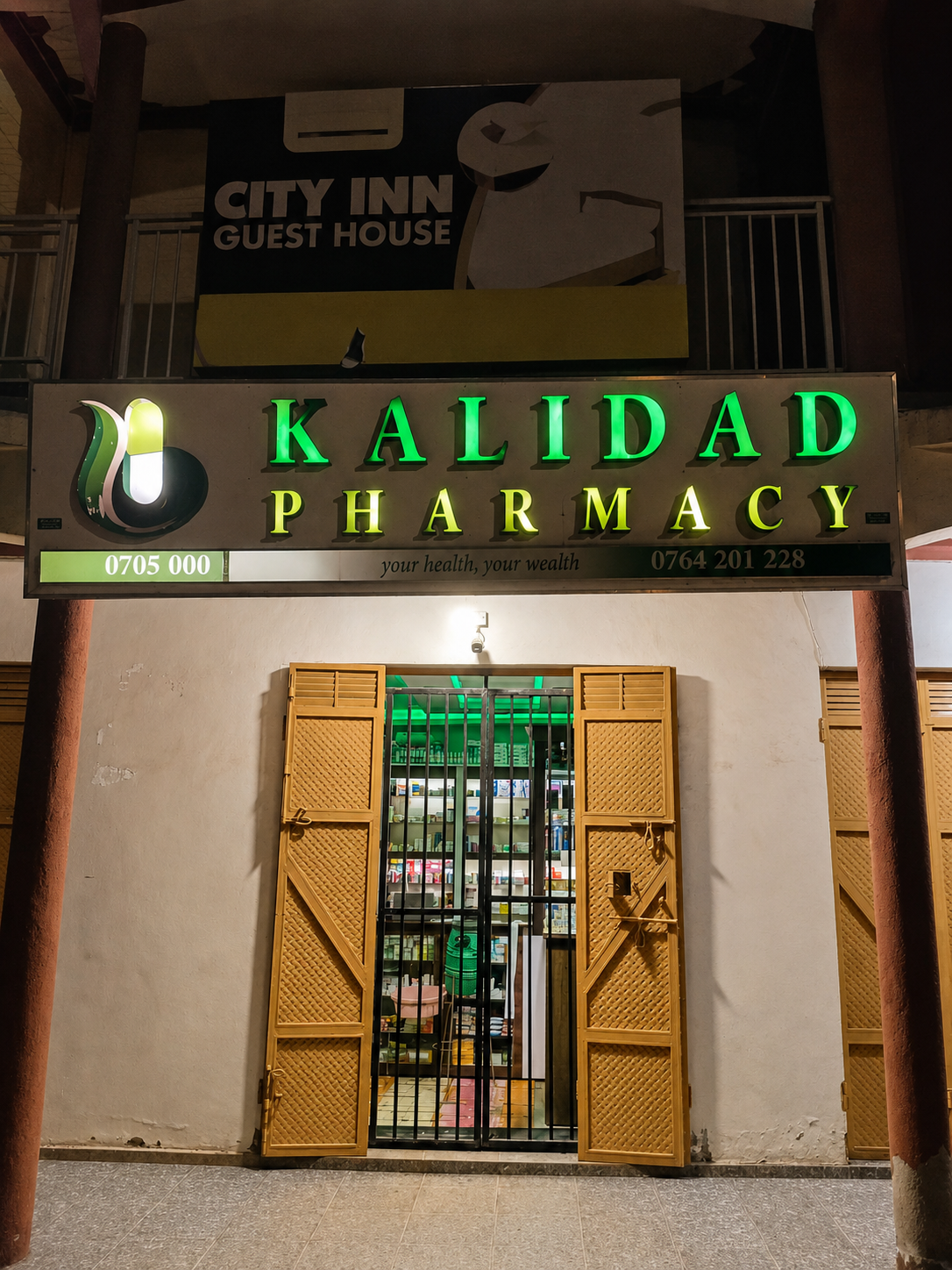 Kalidad Pharmacy Kahungabunyonyi Branch exterior at night