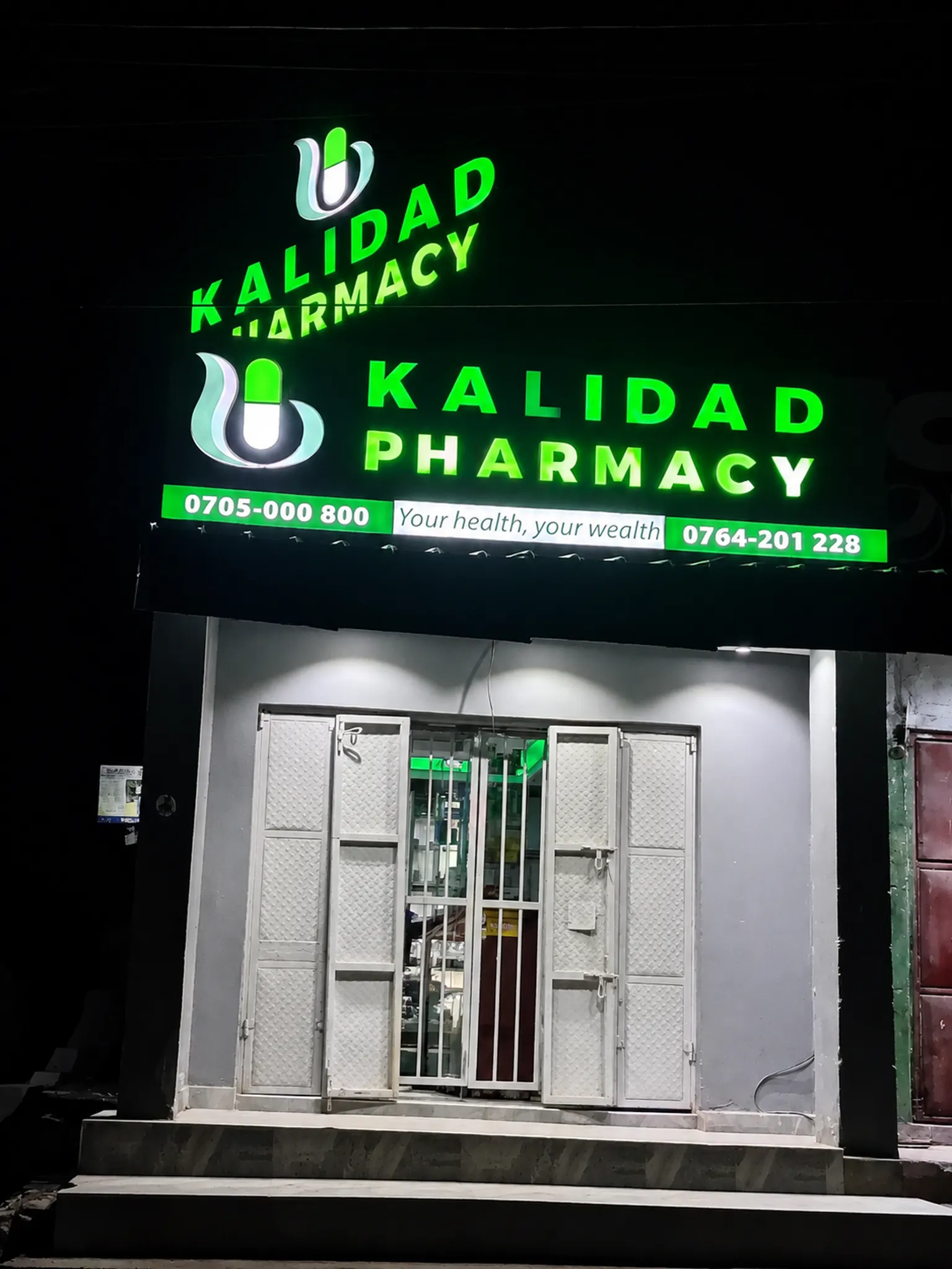 Kalidad Pharmacy Kisenyi Branch exterior at night